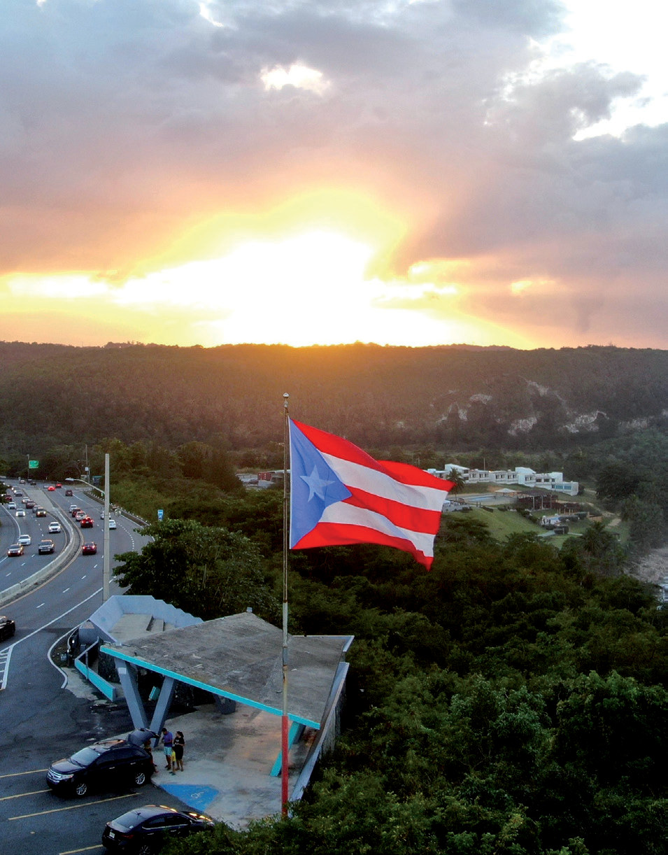 A communications site overlooking Puerto Rico with the Puerto Rican flag at sunset, from the Neptuno case study