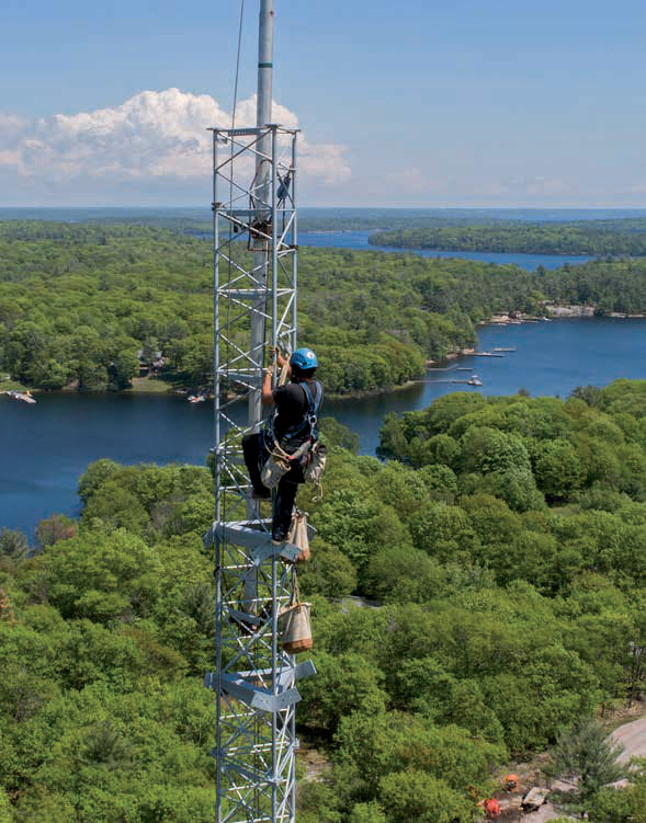 Wireless radio equipment on a tower overlooking an Ontario lake and forest, from the Vianet case study